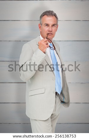 Thinking businessman against wooden planks
