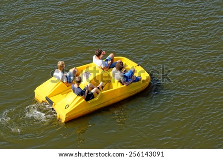 Unidentified people are enjoying a cruise on a pedal boat in Vltava river in Prague, Czech Republic. Royalty-Free Stock Photo #256143091