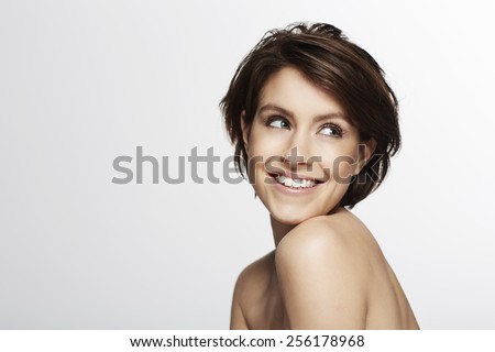 Portrait of beautiful woman looking over shoulder