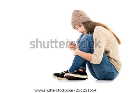 Difficult life situation, relationship problems, rebellious age. Teenage girl holding smartphone, waiting for call or message, looking anxious, copy space