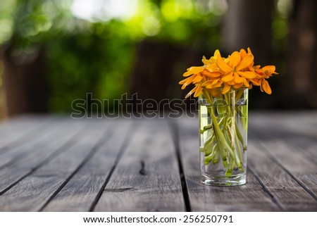 Vase full of colorful flowers on wood table