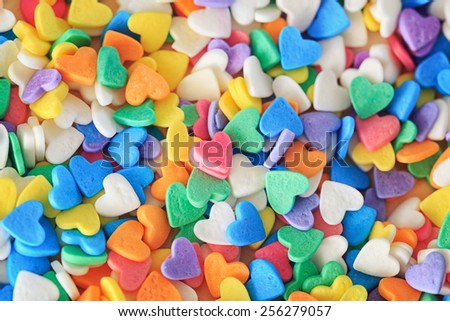 Heap of colorful candies confetti of  heart shape, abstract background, Valentine Day holiday concept, macro photograph, horizontal