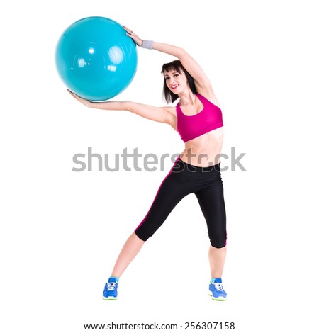 Young smiling woman makes exercise with fitball, full length portrait isolated over white background