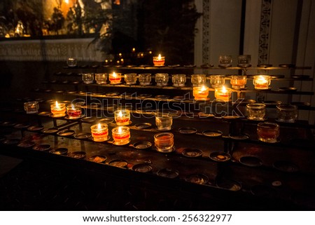 Closeup photo of burning candles on altar at church