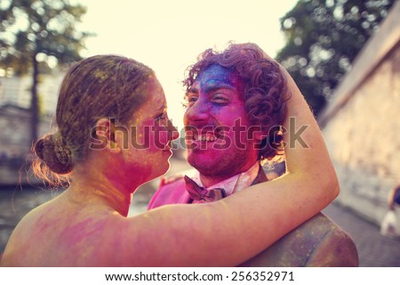 Bride and groom in the city with colorful powder