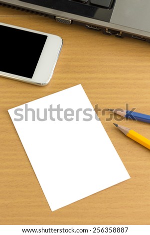 Blank business card with pencil and smartphone on office table