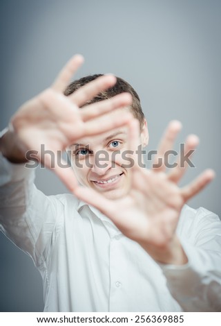 man is framing with his hands