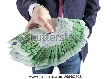 Businessman holding many euros banknotes