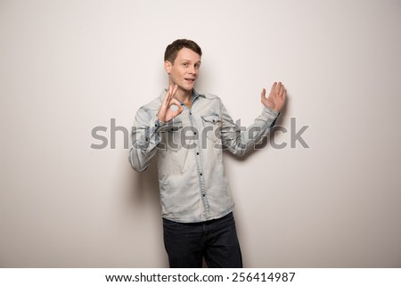 man standing and presenting over empty white wall background