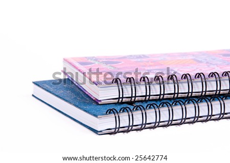 Colorful ring bound books that are isolated on the white background