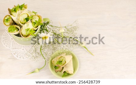 Savory cannoli stuffed with ricotta, peas and parsley. Near bouquet of beautiful flowers. Overhead view. From a series of Italian cuisine.