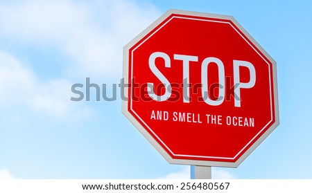 A "stop and smell the ocean" traffic, street sign in southern California