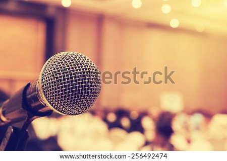 Microphone in concert hall or conference room with defocused bokeh lights in background. Extremely shallow dof.  : Vintage style and  filtered process Royalty-Free Stock Photo #256492474