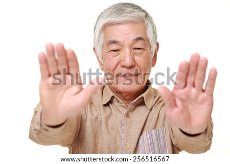senior Japanese man making stop gesture