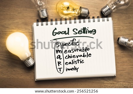 Goal setting as memo on notebook with many light bulbs Royalty-Free Stock Photo #256521256
