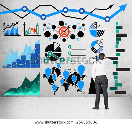 businessman looking to drawing chart and arrows on wall