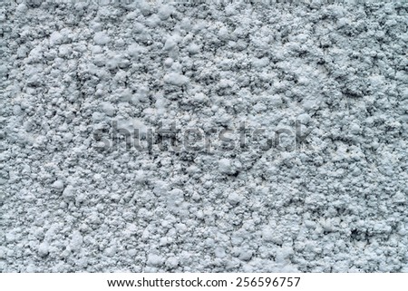Grey wall with pattern of rough cement plaster