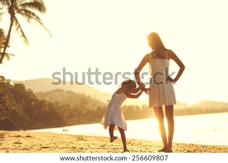 mother and daughter happy in love at sunset
