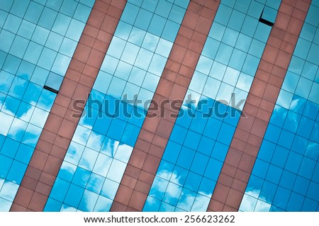 Blue Sky and Clouds Reflected in Modern Business Building Glass Facade