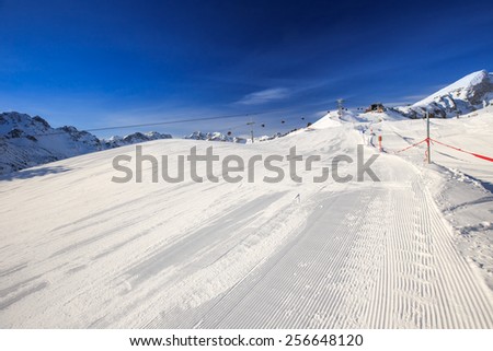 View to Ski slopes with the corduroy pattern and ski chairlifts on the top of Fellhorn Ski resort, Bavarian Alps, Oberstdorf, Germany