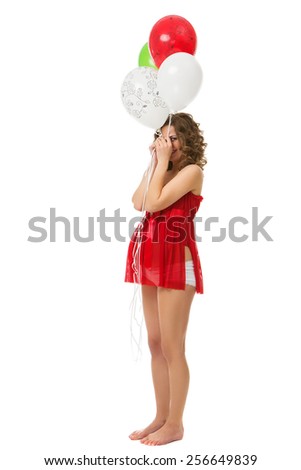 Beautiful pregnant girl wearing red top and holding air balloons