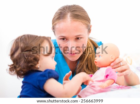 Photo of an adorable baby with her babysitter