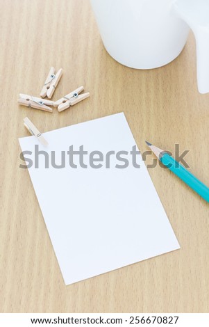 blank paper and wood clip on office table and focus on pencil