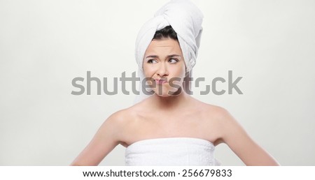 Close up Frustrated Fresh Young Woman Wrapped her Body and Hair with Bath Towel. Isolated on White Background.