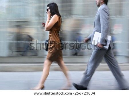  motion blurred business people walking on the street