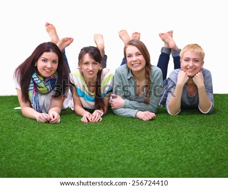 Photo of three woman sitting on grass while looking