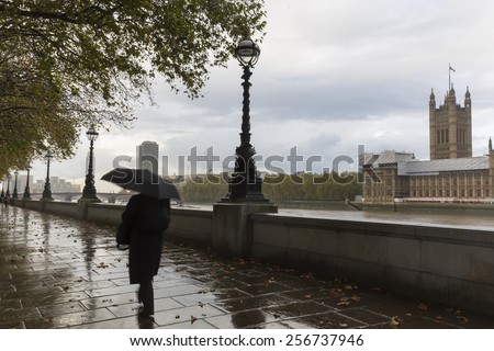 A rainy day on the South Bank of River Thames with Palace of Westminster in Background, London, England, UK