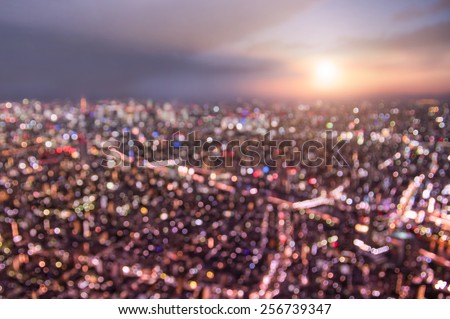 Aerial bokeh of Tokyo skyline from above during sunset and blue hour - Japanese world famous capital with spectacular nightscape panorama - Violet marsala filter on blurred defocused night lights