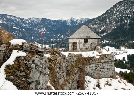 Ancient stone tower of mountain castle in winter time, Austria