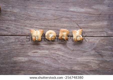 Work text with cookies and blank space on the wooden background