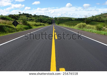 Highway through the trees, grass and bushes. Royalty-Free Stock Photo #25676518