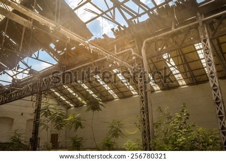 Abandoned industrial interior with bright light rooftop