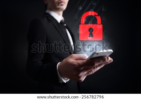 businessman holding a mobile phone with internet and mobile security concept. Internet concept. cyber attack.