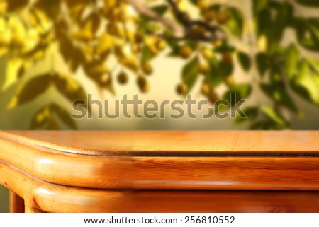 wooden rustic table in front of olives tree