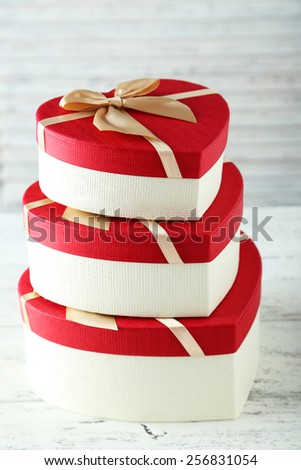 Beautiful heart gift boxes on white wooden background