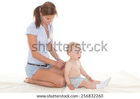 The female doctor with a stethoscope and the small patient on a white background.