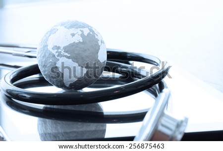 Studio macro of a stethoscope and texture globe with digital tablet with shallow DOF evenly matched abstract as medical network concept
