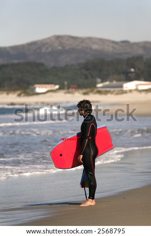 bodyboarder at the coastline