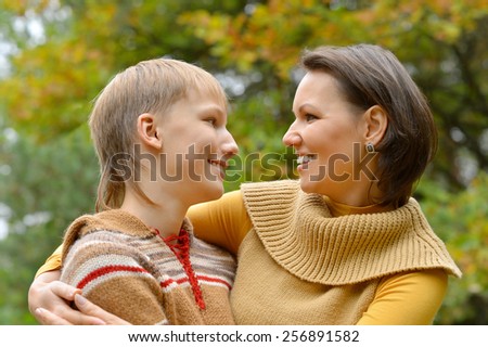 Mother with boy on walk in autumn park