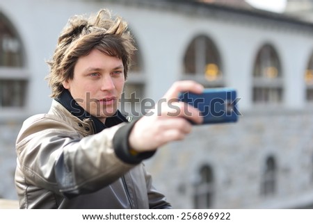 Student / tourist taking self portrait in the europe street