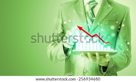 business man using tablet computer to work with financial data
