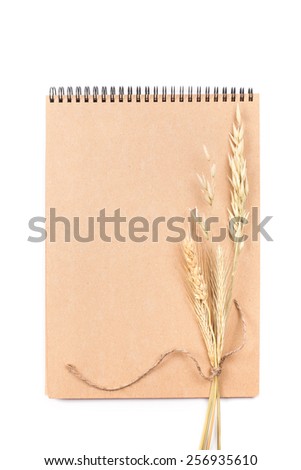 Eco notepad with spikelets of wheat isolated on white