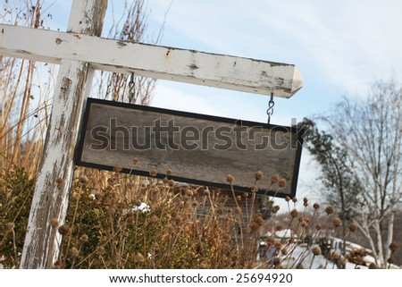 A blank, rustic wooden sign with signs of wear.