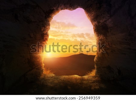 Empty tomb with three crosses on a hill side. Royalty-Free Stock Photo #256949359