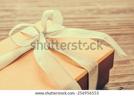 Gift box on wood background - vintage effect style pictures