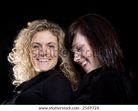 Two Pretty woman friends laughing